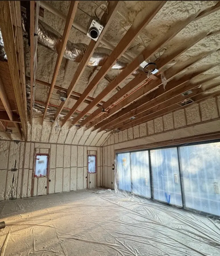 Interior walls and ceiling insulated with spray foam during new construction in Laketown